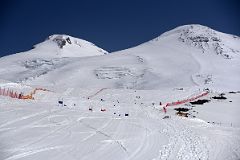 
Skiers With Mount Elbrus West And East Summits Morning From Garabashi Camp On Mount Elbrus Climb
